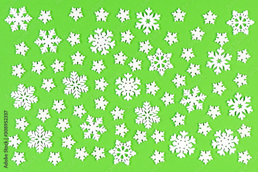 Set of white snowflakes on colorful background. Top view of Christmas ornament. New Year time concept with empty space for your design