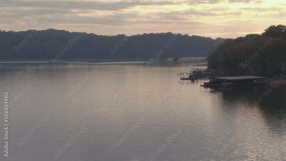 Low altitude aerial view of early morning back lit lake shoreline