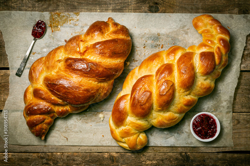 Obraz na płótnie Traditional jewish bread challah on wood background, top view