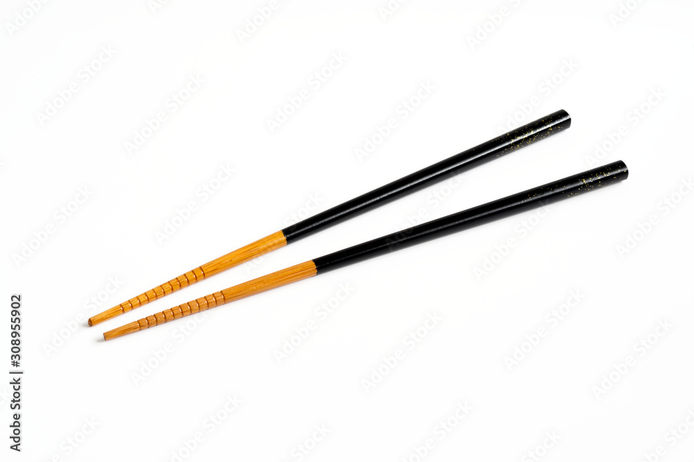 Black and brown wooden chopsticks on white background.