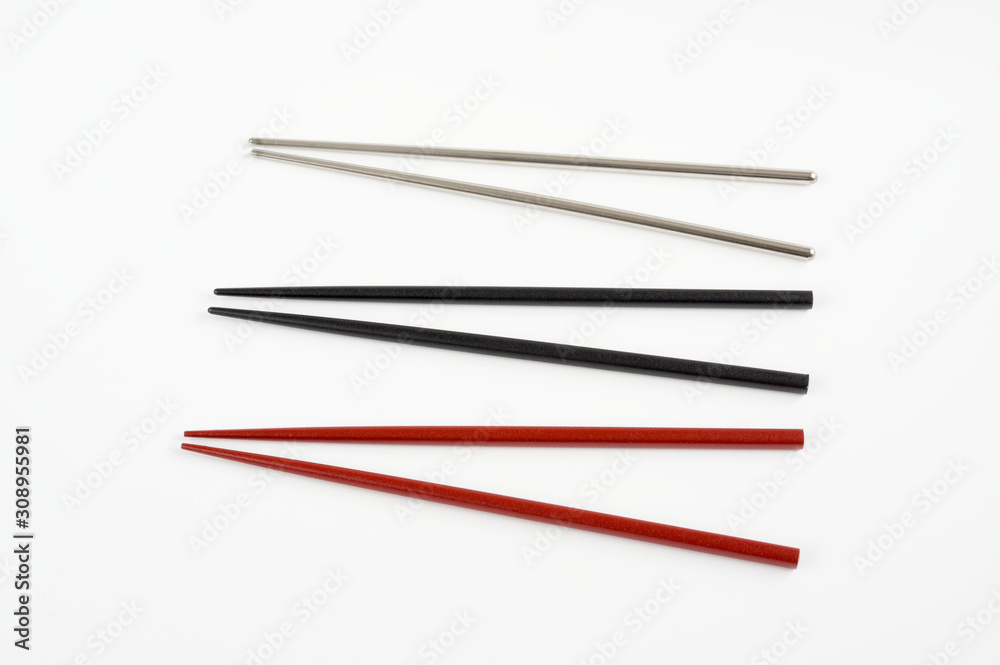 Wooden red , black and metal grey chopstick on white . Wooden red , black and metal grey chopstick on white .