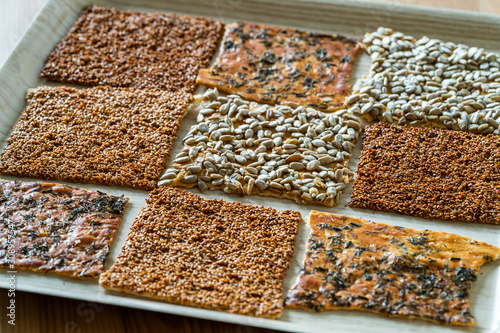 Turkish Homemade Snacks Biscuit with Sunflower Seeds, Sesame and Dill /Crispy Yaprak Galeta with Traditional Tea on Tray.