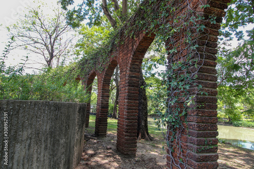 Brick pillar overgrown with ivy