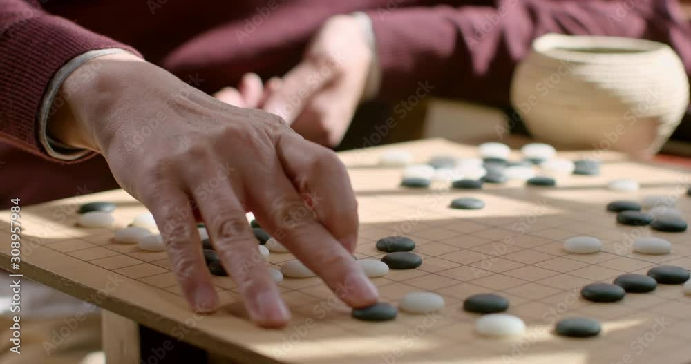 Father and son playing the game of go,4K Father and son playing the game of go,4K