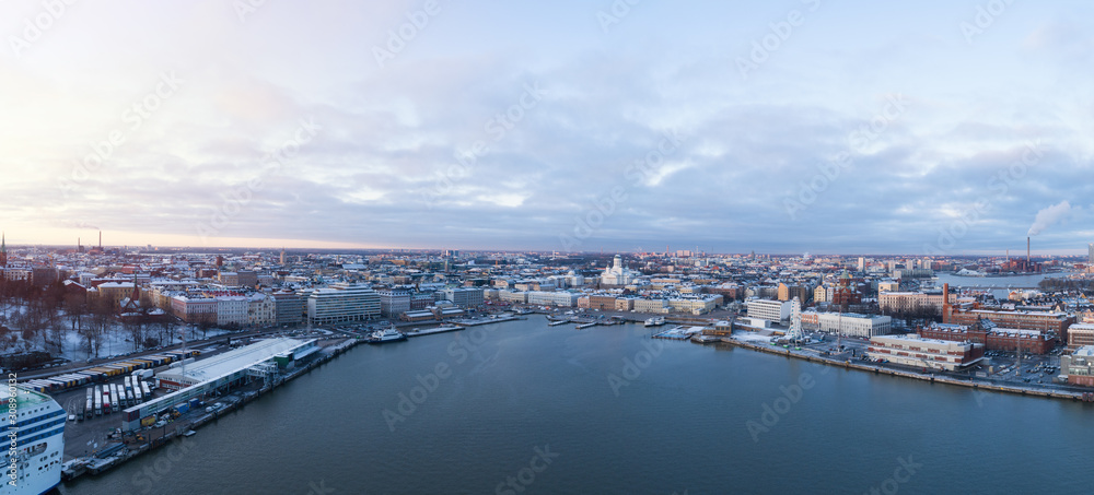  Aerial view Of Helsinki city from the sea. Sunset Evening Illuminations. Scenic winter view of the Old Port from the air. Finland. 