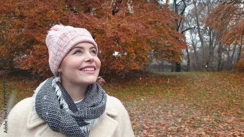 Attractive young woman snow falling winter time Central Park New York city