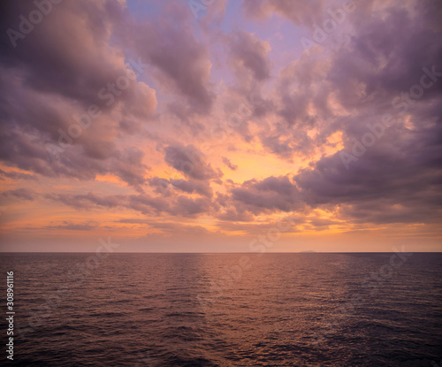 Background image of the ocean in summer time. Beautiful dramatic sunset sky over the sea at tropical beach in the evening with filter. copy space. South of  Thailand  Andaman sea  Indian ocean.