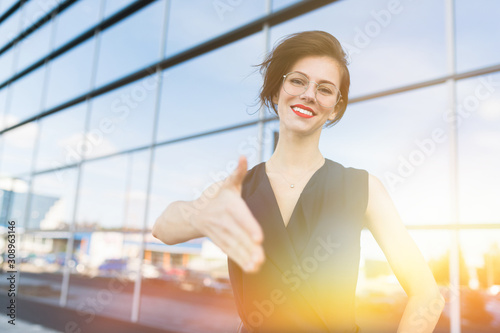 Caucasian woman in office clothes waits colleague near the office building Free Download Caucasian woman in office clothes waits colleague near the office building - GFXLoad