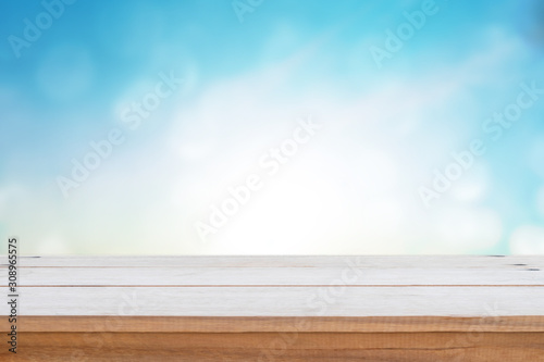 Empty wood table top on blur nature background.