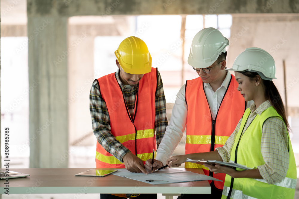 Group of engineer architect and foreman officer meeting about construction working plan on building site Group of engineer architect and foreman officer meeting about construction working plan on building site