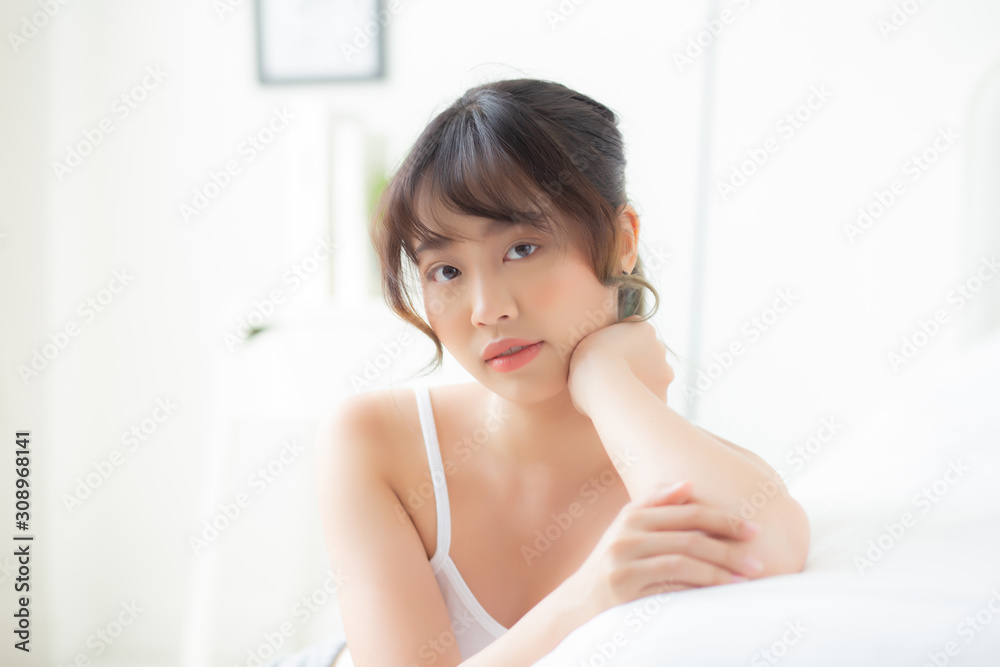 Portrait beautiful young asian woman smile while wake up healthy and wellness at morning on bed, beauty asia girl happy lying skin care and makeup cosmetic at bedroom, lifestyle and relax concept. Portrait beautiful young asian woman smile while wake up healthy and wellness at morning on bed, beauty asia girl happy lying skin care and makeup cosmetic at bedroom, lifestyle and relax concept.