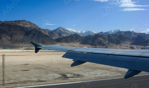 View of airplane wing against mountains