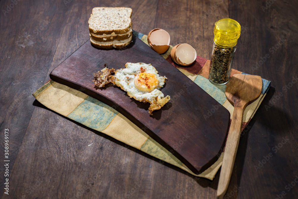 Spiced scrambled fried eggs on wooden board Spiced scrambled fried eggs on wooden board