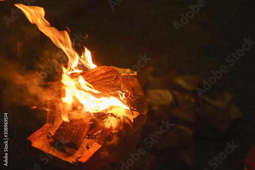 Red hot fire charcoal with burning tree leaves