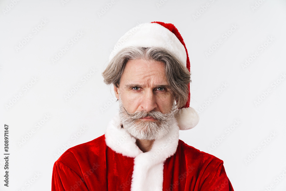 Image of gray-haired old Santa Claus man in red costume frowning at camera Image of gray-haired old Santa Claus man in red costume frowning at camera