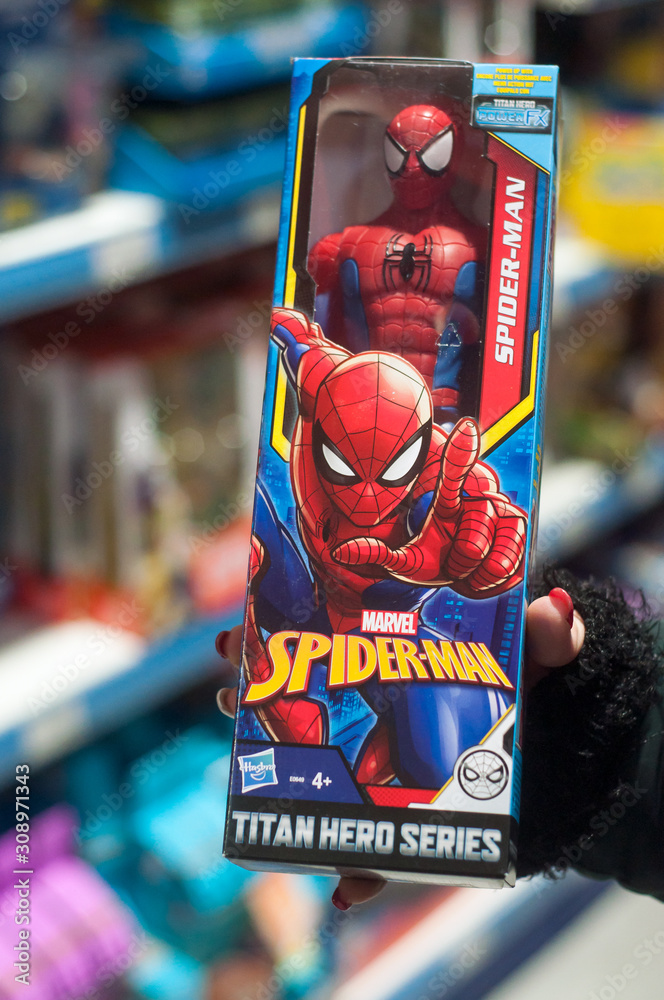 Obraz premium Mulhouse - France - 7 December 2019 - Closeup of Spider man figurine in hand of woman in a toys store supermarket