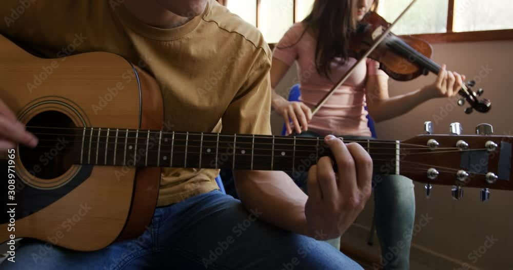 Teenage musicians rehearsing
