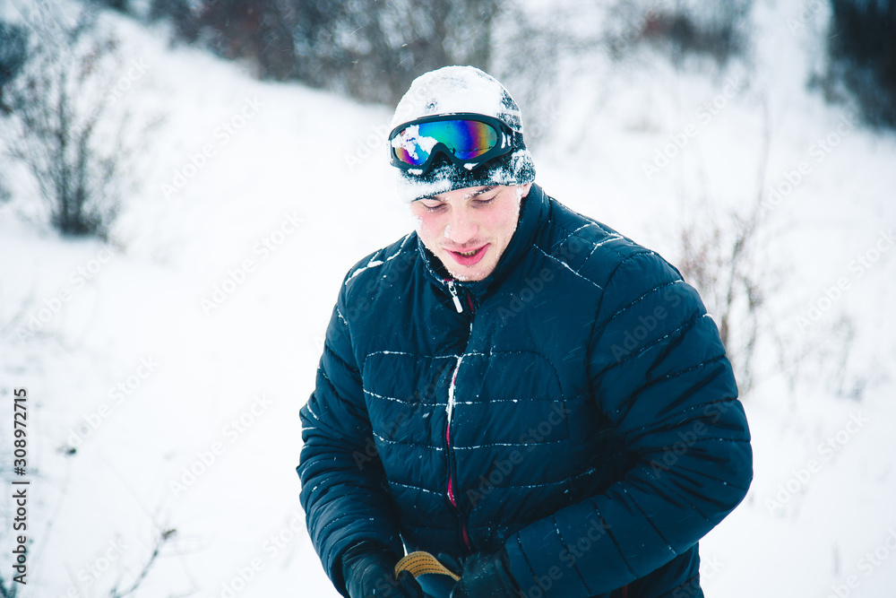 Happy young man with snowboard enjoying sunny weather in snowy mountains. Winter sport and recreation, leasure outdoor activities. Happy young man with snowboard enjoying sunny weather in snowy mountains. Winter sport and recreation, leasure outdoor activities.