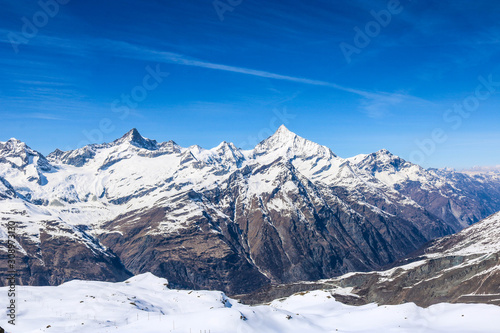 Panoramic landscape of snow mountain range in Switzerland with sunny day