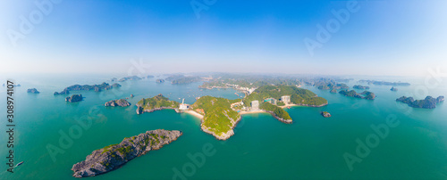 Aerial view: clear blue sky at Cat Ba island and beach, the biggest island in Ha Long Bay, unique limestone rock islands and karst formation peaks in the sea, famous tourism destination in Vietnam photo