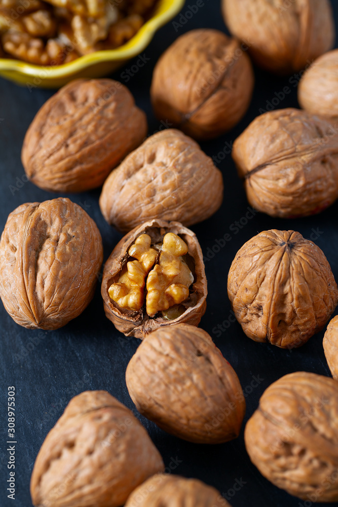 walnuts on black stone surface walnuts on black stone surface