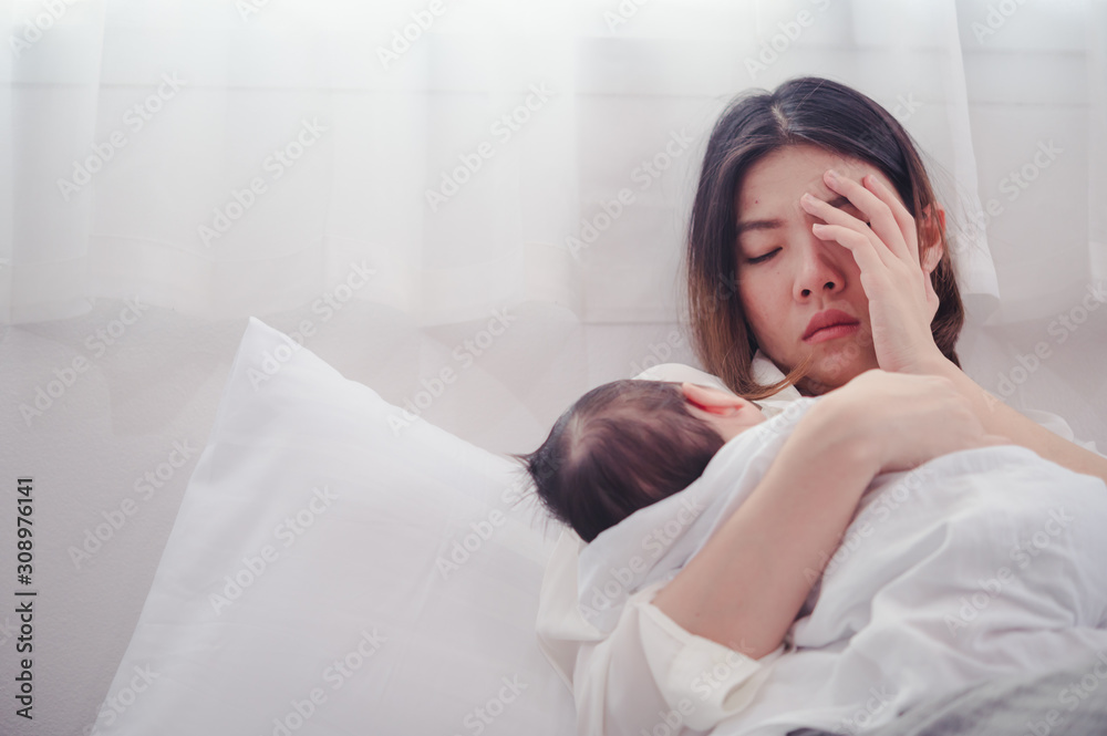 Tired Mother Suffering from experiencing postnatal depression.Health care single mom motherhood stressful.
