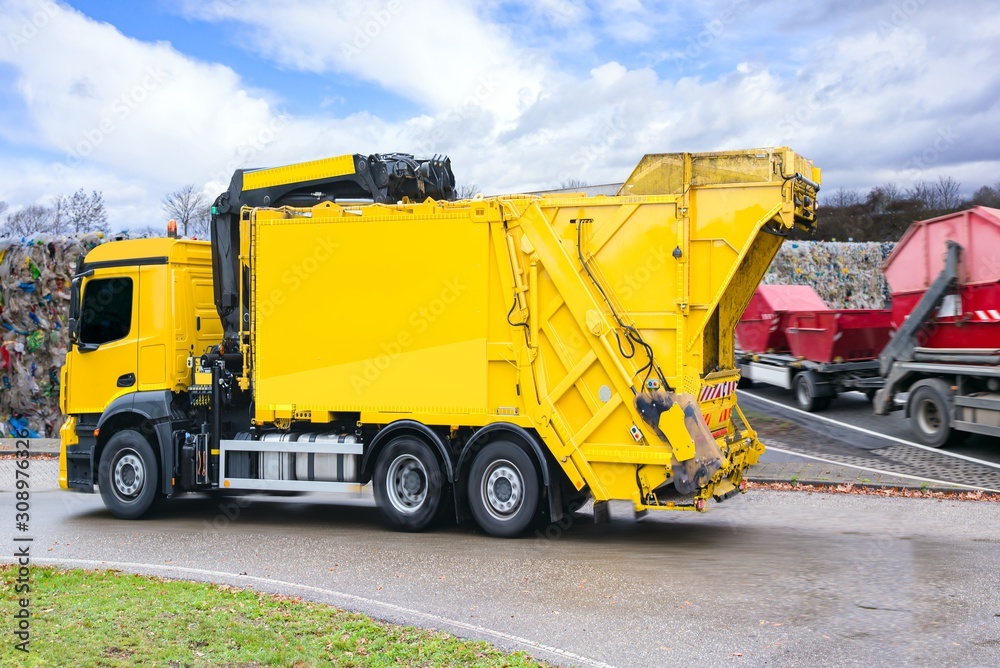 Urban recycling waste and garbage services , Bright yellow truck Urban recycling waste and garbage services , Bright yellow truck