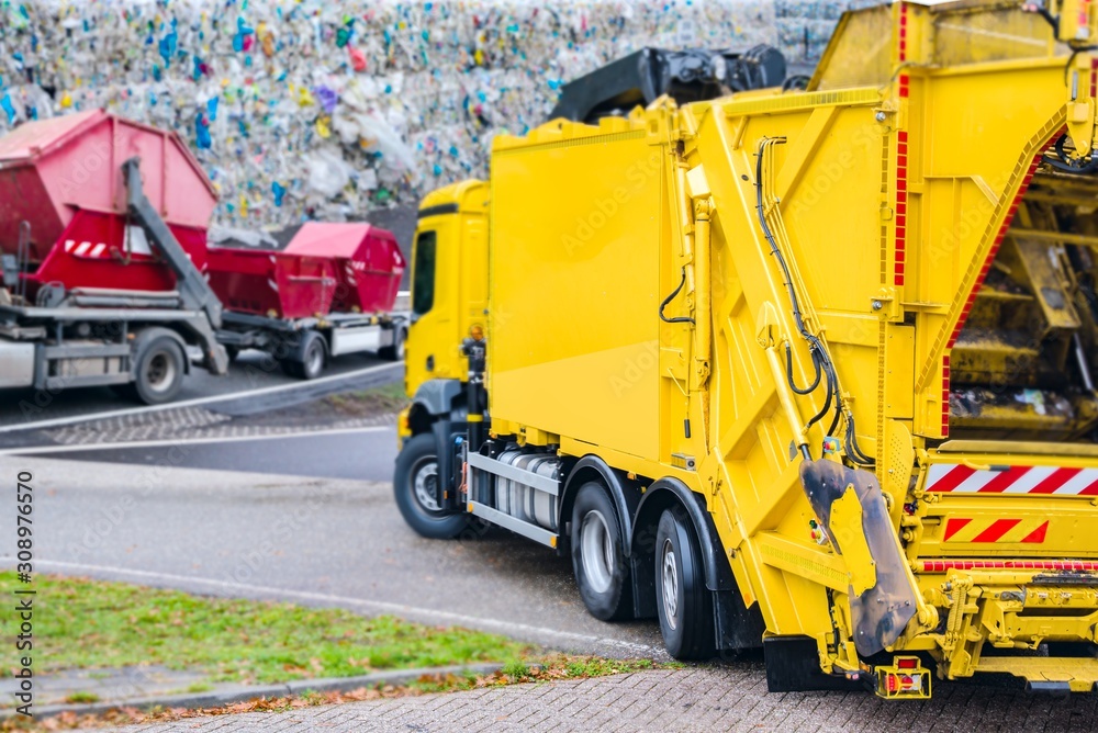 Urban recycling waste and garbage services , Bright yellow truck Urban recycling waste and garbage services , Bright yellow truck