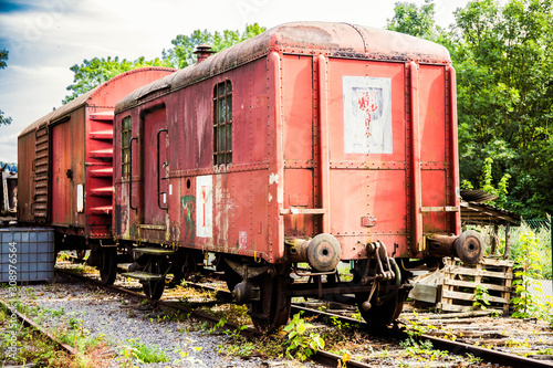 Various rusted wagons and train on the tracks