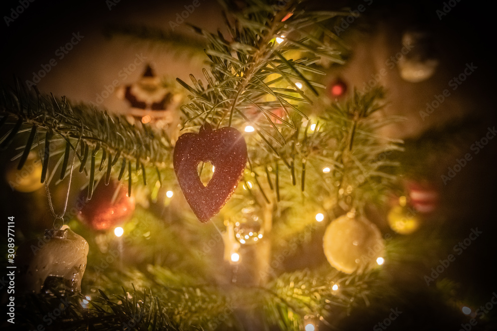 Decorated Christmas Tree with light string, stars, baubles and a red heart