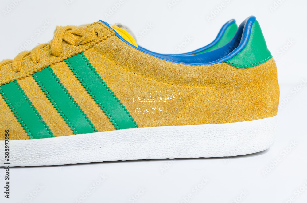 london, england, 05/05/2018 Adidas Gazelle Mustard Gold & Green Stripe  Trainers vintage sneaker trainers. yellow suede adidas trainers, stylish  retro football street fashion. famous three stripes Stock Photo | Adobe  Stock