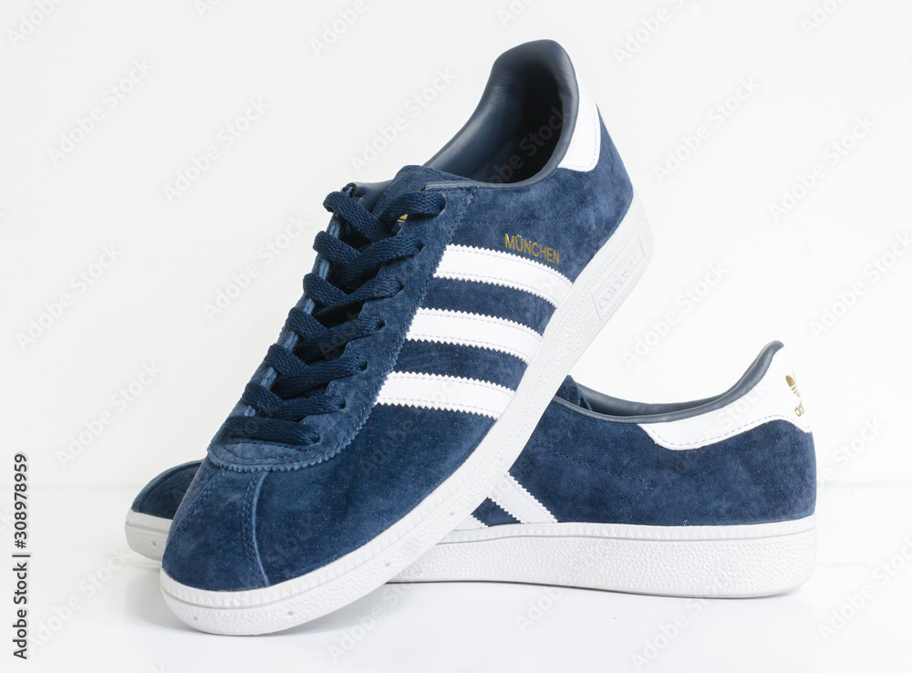 london, england, 05/05/2018 Adidas Munchen gazelle vintage sneaker trainers.  Blue suede adidas trainers, stylish retro football street fashion. famous  three stripes Stock Photo | Adobe Stock