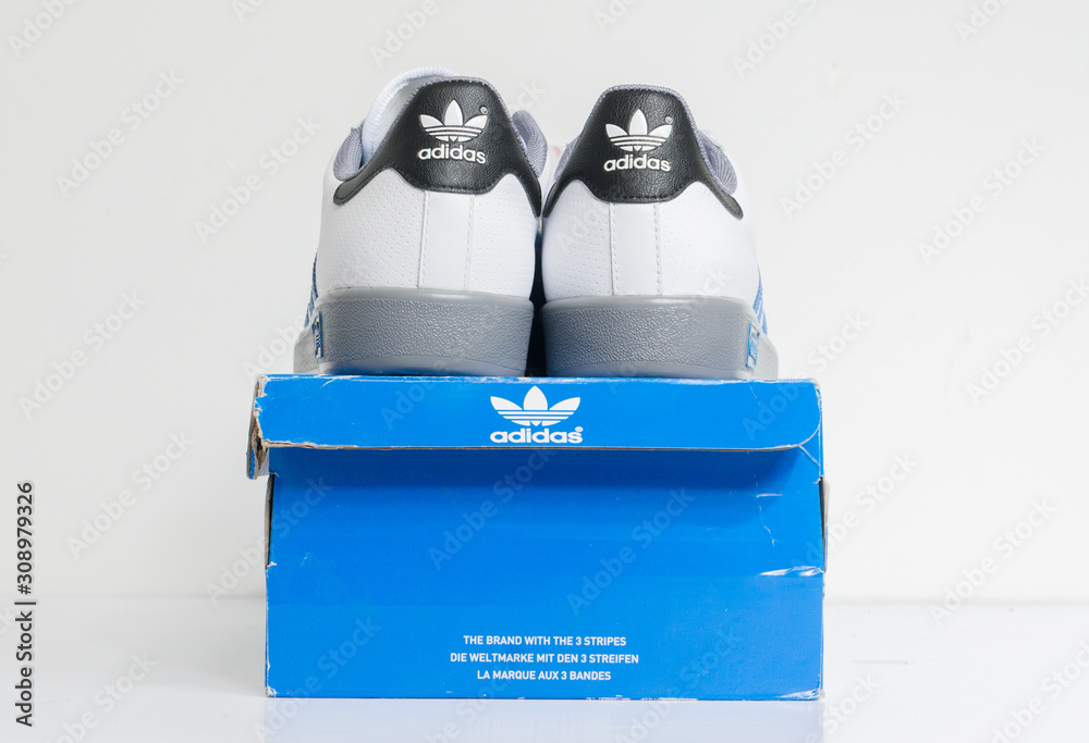 london, england, 05/05/2018 Adidas Forest Hills White grey blue vintage sneaker trainers. Blue stripe adidas trainers, stylish retro street fashion. famous three stripes de Stock | Adobe Stock