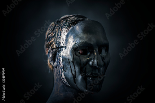 Fototapeta Scary figure with creepy bloody mask in the dark