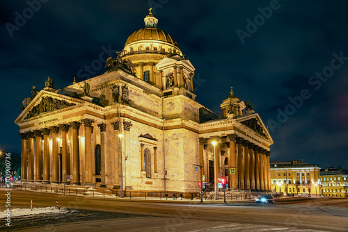 facade of St. Isaac's Cathedral in the rays of light against the night sky in St. Petersburg, Russia