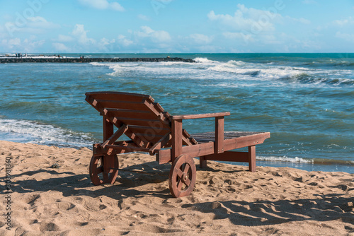 one deck chair on the sandy beach of the Italian resort town of Lido di Ostia against the blue sea