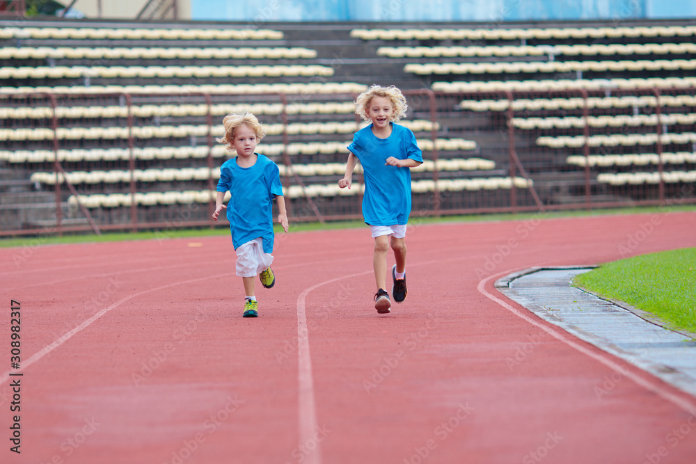 Fototapeta premium Child running in stadium. Kids run. Healthy sport.