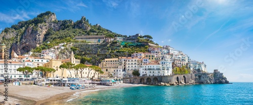 Fototapeta Naklejka Na Ścianę i Meble -  Panoramic view of beautiful Amalfi on hills leading down to coast, comfortable beaches and azure sea in Campania, Italy.
