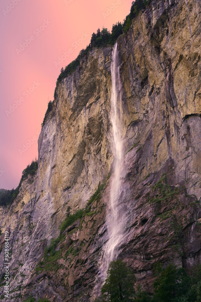 Beautiful waterfall in the high mountains of Switzerland. Magic light at sunset in Lauterbrunnen, canton of Bern, Switzerland.