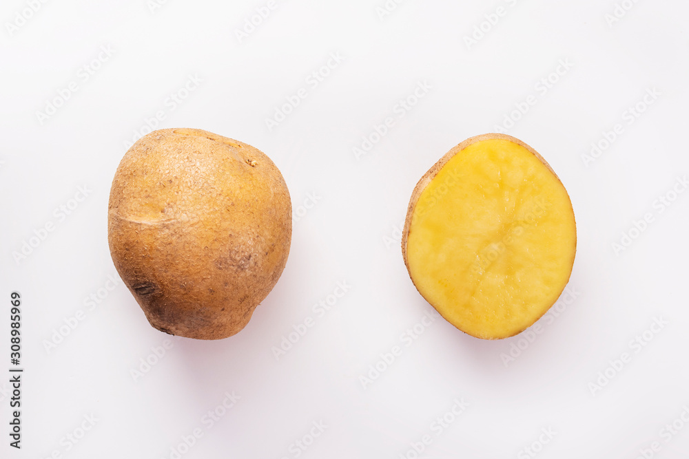 whole and cut potatoes on a white background whole and cut potatoes on a white background