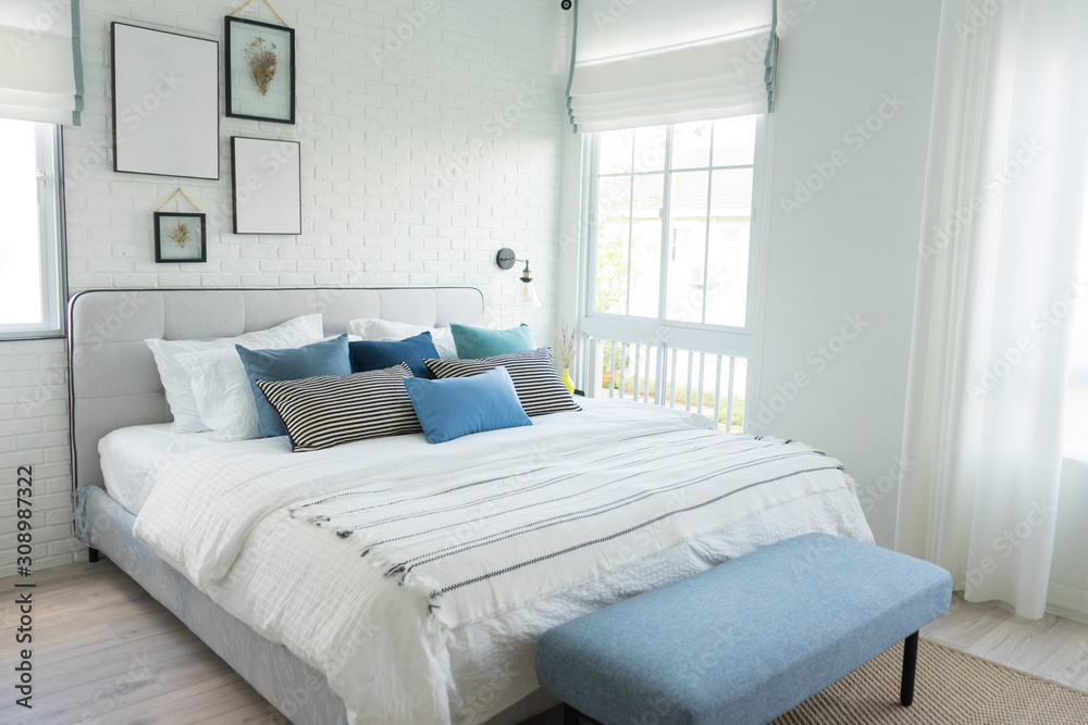 White and blue spacious bedroom with a large bed, in the Scandinavian style. Mockup and free space for text and pictures