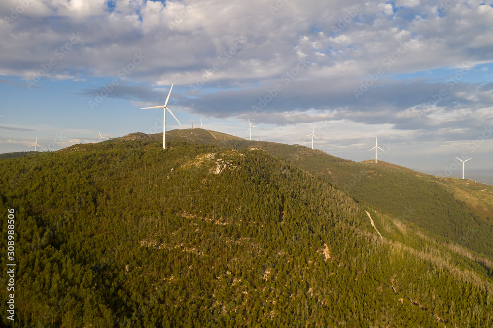 wind turbines on a forest covered mountain wind turbines on a forest covered mountain