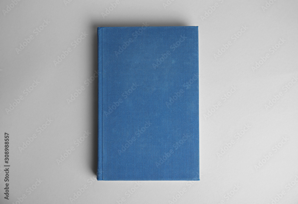 Hardcover book on light grey background, top view. Space for design Hardcover book on light grey background, top view. Space for design