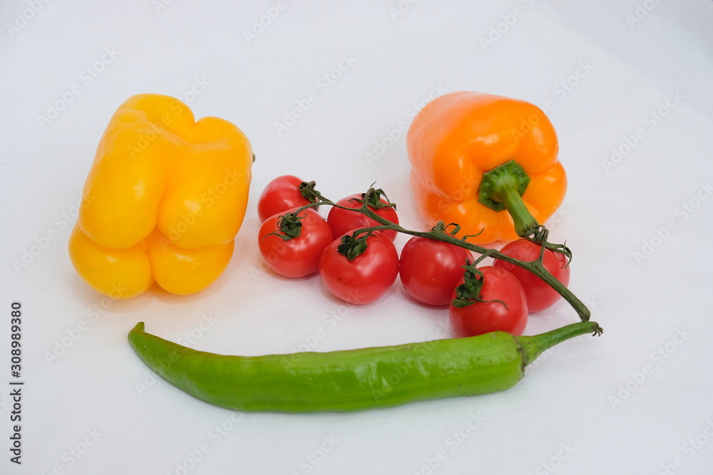 Variety of colorful red, green, yellow paprika bell peppers, tomatoes Healthy eating food