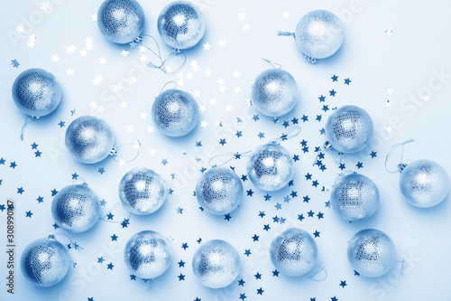 Christmas composition. Balls and sparkles on paper background. Christmas, winter, new year concept. Color of the year 2020 classic blue toned
