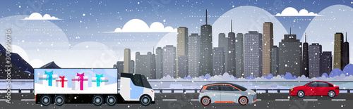 cars and delivery semi truck driving road merry christmas happy new year snowy city street modern cityscape background horizontal vector illustration