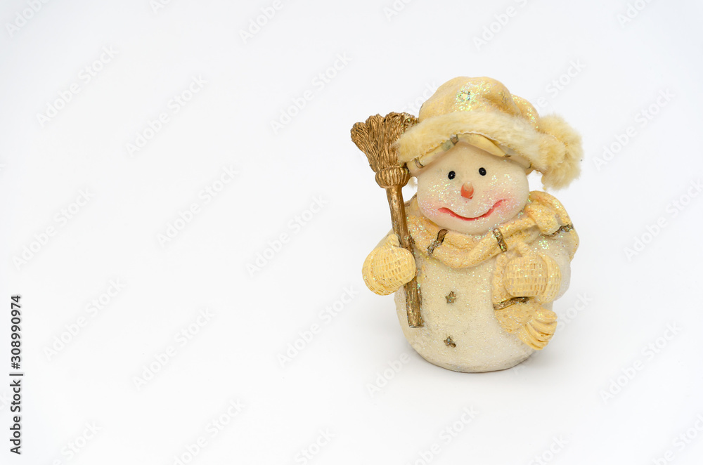 Cute cheerful snowman figurine with a broom on a white background. Minimal christmas composition. Layout for festive background with copy space. Closeup