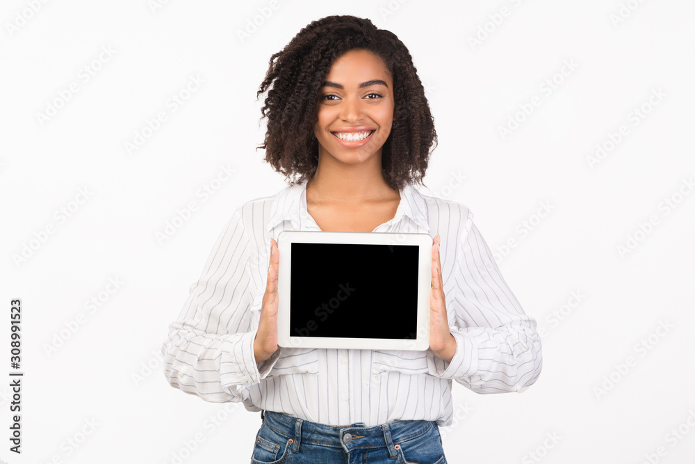 Smiling african american girl showing tablet screen Smiling african american girl showing tablet screen