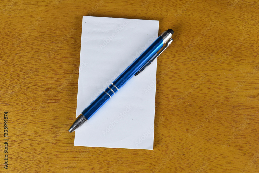 pen with notepad on a table pen with notepad on a table