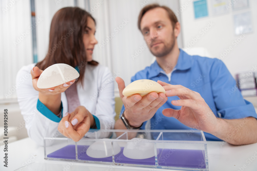 Obraz premium Two plastic surgeons discussing silicone breast implants